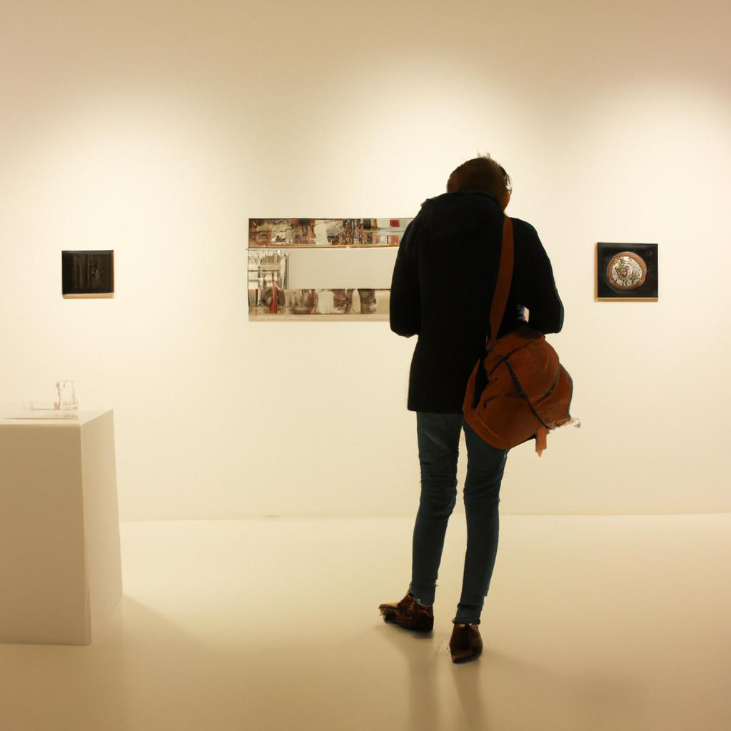 Person exploring art gallery exhibits