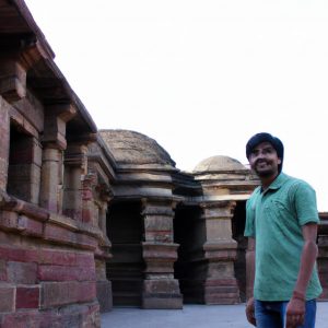 Person exploring historical monument, smiling